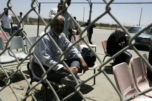 Palestinians wait to cross into Egypt through the Rafah border crossing in the southern Gaza Strip on May 30, 2011. Egypt eased travel restrictions for residents of Gaza from Saturday, and eroding a blockade that imposed...