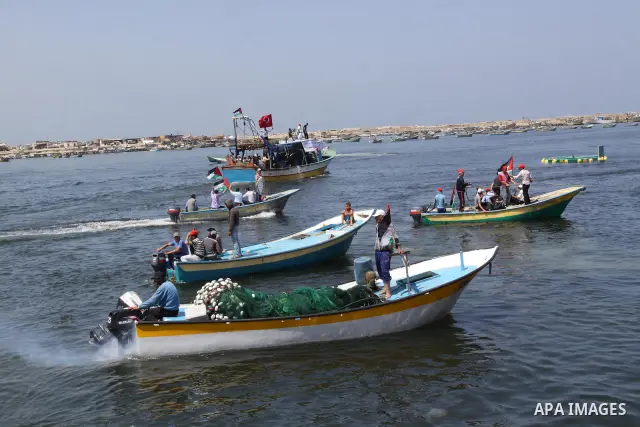 Palestinians ride boats in the Mediterranean Sea off the coast of Gaza City May 30, 2011, during a rally marking the first anniversary of the death of nine Turks, who were shot dead last May when Israeli naval commandos...