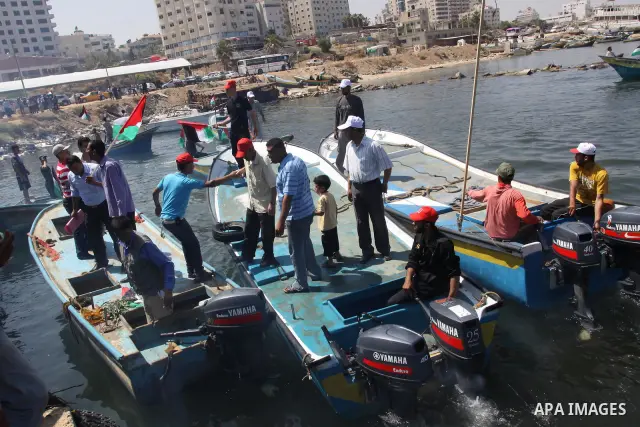 Palestinians ride boats in the Mediterranean Sea off the coast of Gaza City May 30, 2011, during a rally marking the first anniversary of the death of nine Turks, who were shot dead last May when Israeli naval commandos...