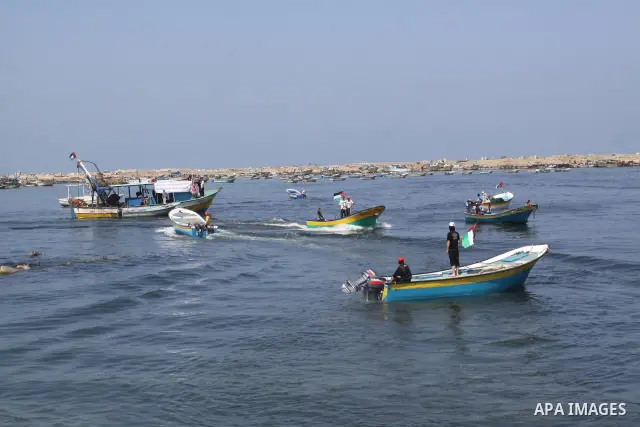 Palestinians ride boats in the Mediterranean Sea off the coast of Gaza City May 30, 2011, during a rally marking the first anniversary of the death of nine Turks, who were shot dead last May when Israeli naval commandos...