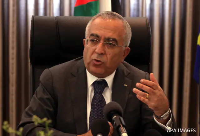 Palestinian Prime Minister Salam Fayyad attend a joint press conference with the Representative of Japan, Naofumi Hashimoto and the EU Representative, Christian Berger during signing an agreement in the West Bank city of...