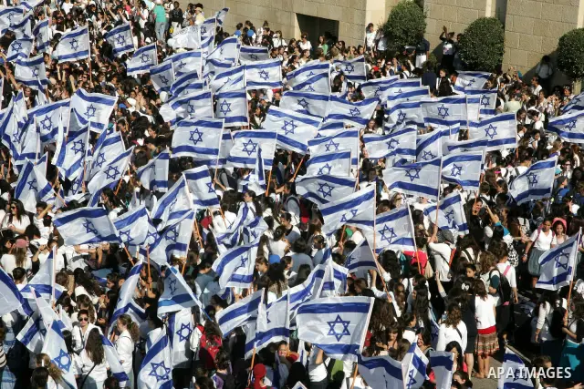 Israelis wave their national flag on July 1, 2011 as some 40,000 Jewish Israelis joined a Jerusalem Day parade in the city's mainly Arab eastern sector to celebrate its capture 44 years ago, during the Six Day War. Photo...