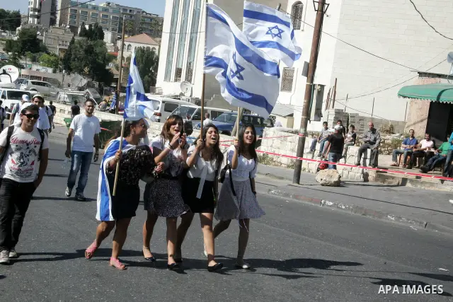 Israelis wave their national flag on July 1, 2011 as some 40,000 Jewish Israelis joined a Jerusalem Day parade in the city's mainly Arab eastern sector to celebrate its capture 44 years ago, during the Six Day War. Photo...