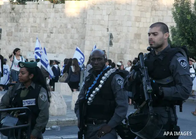 Israeli soldiers stand guard as Israelis march at Damascus Gate, the main entrance to the old city of Jerusalem on June 1, 2011 as some 40,000 Jewish Israelis joined a Jerusalem Day parade in the city's mainly Arab easte...