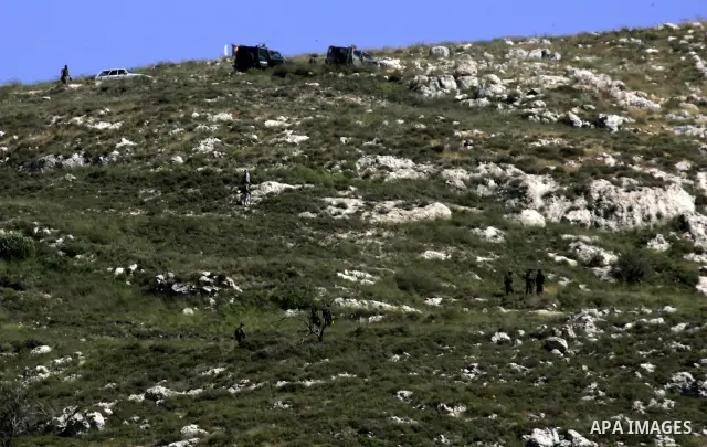 Jewish settlers from the settlement of Yitzhar throw stones at Palestinian farmers over farming land between the the outskirts of the West Bank village of Madama near the Jewish settlement of Yitzhar, Thursday June 2, 20...