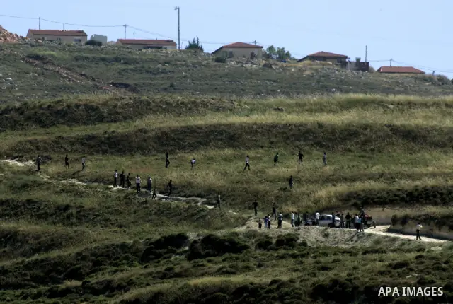 Jewish settlers from the settlement of Yitzhar throw stones at Palestinian farmers over farming land between the the outskirts of the West Bank village of Madama near the Jewish settlement of Yitzhar, Thursday June 2, 20...