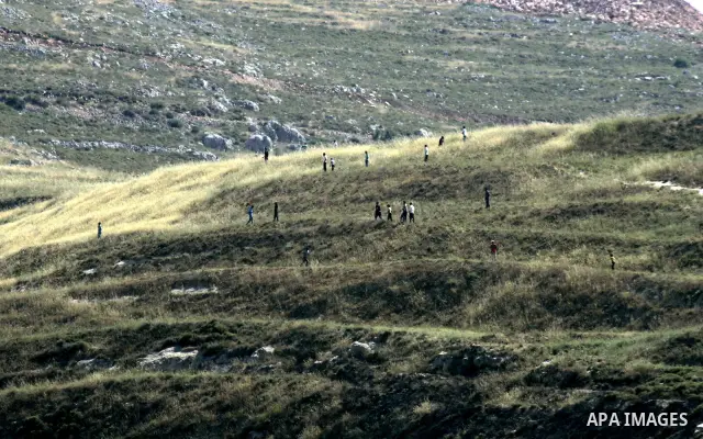 Jewish settlers from the settlement of Yitzhar throw stones at Palestinian farmers over farming land between the the outskirts of the West Bank village of Madama near the Jewish settlement of Yitzhar, Thursday June 2, 20...