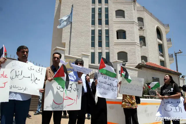 Palestinians protest in front of the UN headquarters in the West Bank city of Ramallah against UN chief Ban Ki-moon's call "on all governments" in the region to use to their influence to push against a new flotilla of sh...