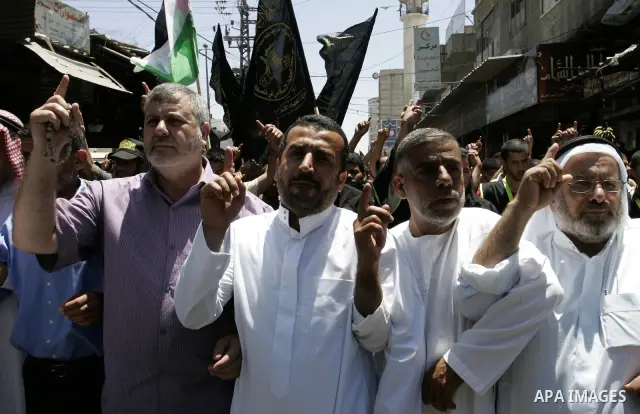 Palestinian Islamic Jihad supporters shout slogans as they march in the Khan Yunis refugee camp in the southern Gaza Strip on June 03, 2011 to mark the 44th anniversary of Six Day War and the annexation of east Jerusalem...