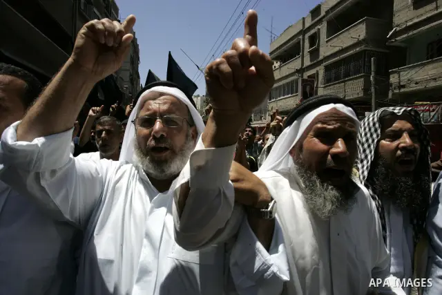 Palestinian Islamic Jihad supporters shout slogans as they march in the Khan Yunis refugee camp in the southern Gaza Strip on June 03, 2011 to mark the 44th anniversary of Six Day War and the annexation of east Jerusalem...