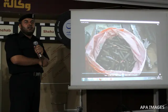 A Palestinian policeman from the Islamic Hamas movement displays a video for confiscated drugs and drug addicts and dealers in Gaza City on June 3, 2011, following a military operation. Drug use was once rare in Gaza's c...