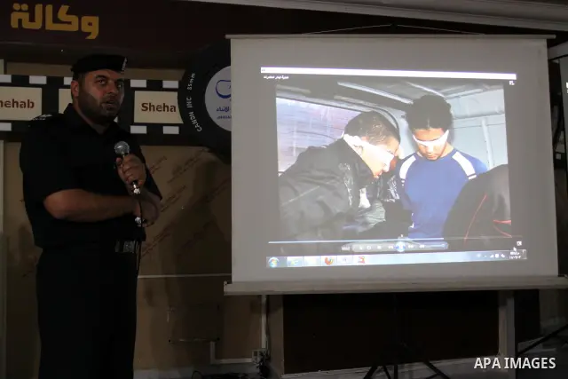 A Palestinian policeman from the Islamic Hamas movement displays a video for confiscated drugs and drug addicts and dealers in Gaza City on June 3, 2011, following a military operation. Drug use was once rare in Gaza's c...