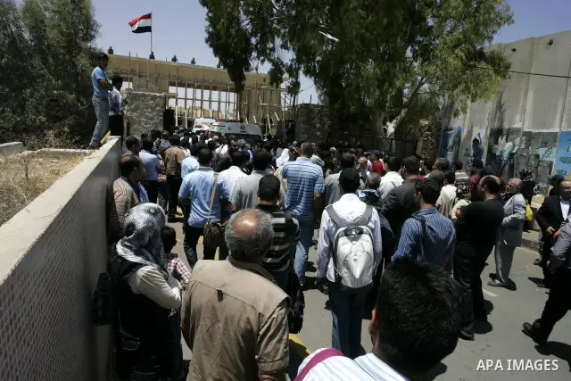 Palestinians wanting to cross into Egypt through the Rafah border crossing are stopped on June 4, 2011, as Egyptian officials at the border with Gaza barred Palestinians from crossing, but later allowed them passage out...