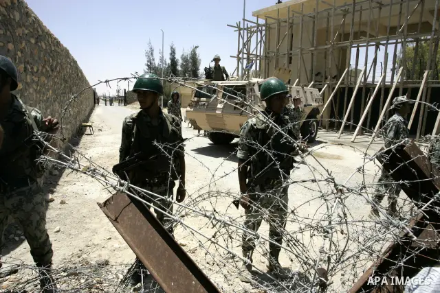 Egyptian security form a line while a Palestinian man shouts wanting to cross into Egypt through the Rafah border crossing on June 4, 2011, as Egyptian officials at the border with Gaza barred Palestinians from crossing,...