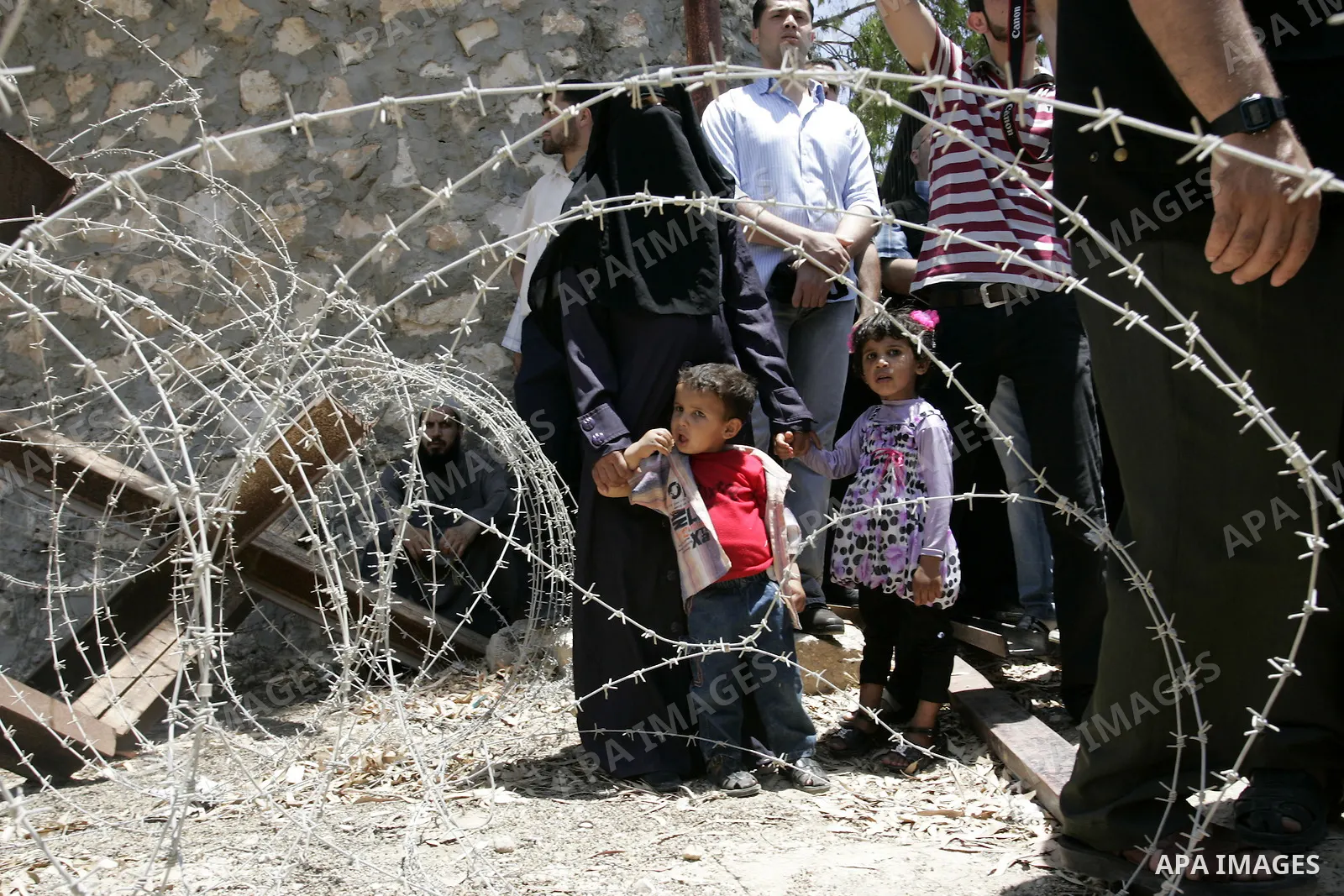 Palestinians wanting to cross into Egypt through the Rafah border crossing are stopped on June 4, 2011, as Egyptian officials at the border with Gaza barred Palestinians from crossing, but later allowed them passage out...