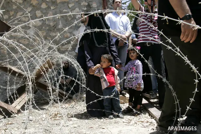 Palestinians wanting to cross into Egypt through the Rafah border crossing are stopped on June 4, 2011, as Egyptian officials at the border with Gaza barred Palestinians from crossing, but later allowed them passage out...
