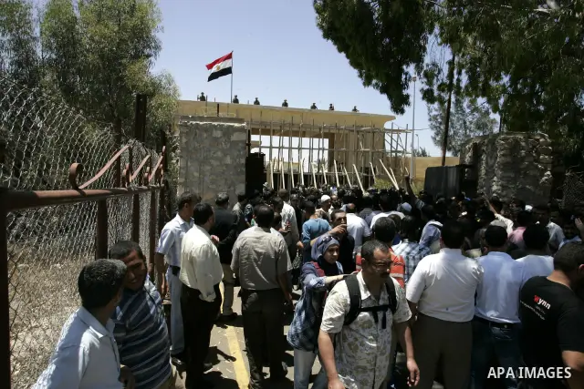 Palestinians wanting to cross into Egypt through the Rafah border crossing are stopped on June 4, 2011, as Egyptian officials at the border with Gaza barred Palestinians from crossing, but later allowed them passage out...