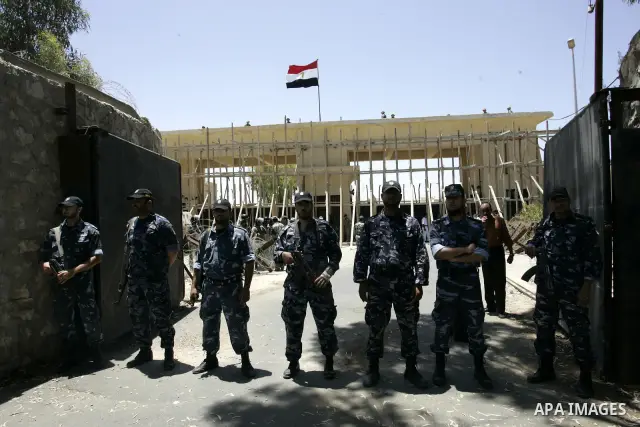Hamas policemen stand in front of Egyptian soldiers as they prevent Palestinians from coming close to the iron gate of a border crossing with Egypt in the southern Gaza strip June 4, 2011. Egyptian officials at the borde...