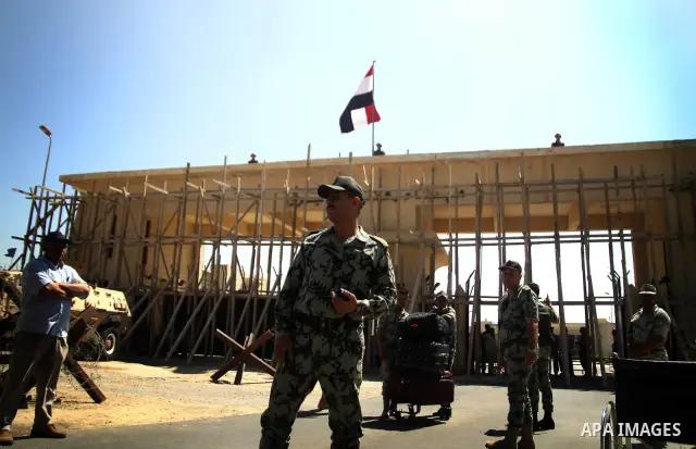 Egyptian soldiers help Palestinian passengers at the Rafah border crossing in the southern Gaza Strip 04 June 2011. Egyptian authorities reopened its Rafah border crossing with the Gaza Strip after a temporary closure wh...