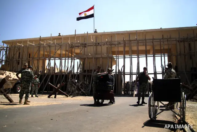 Egyptian soldiers help Palestinian passengers at the Rafah border crossing in the southern Gaza Strip 04 June 2011. Egyptian authorities reopened its Rafah border crossing with the Gaza Strip after a temporary closure wh...