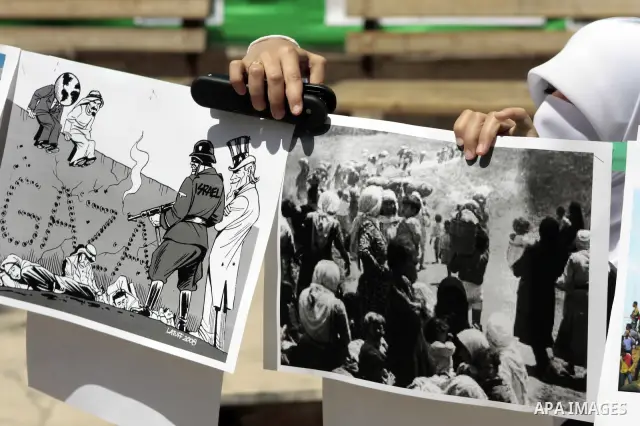 Palestinian Hamas supporters organize a photo gallery for practices of Israeli occupation soldiers and the 44th anniversary of 'Naksa,' Arabic for setback, during a protest in the West Bank city of Hebron on June 05, 201...