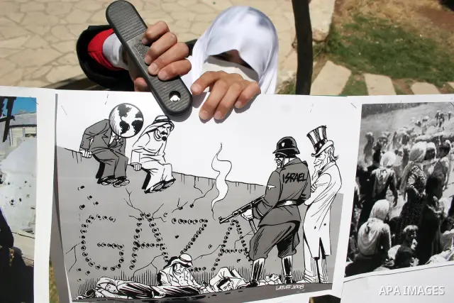 Palestinian Hamas supporters organize a photo gallery for practices of Israeli occupation soldiers and the 44th anniversary of 'Naksa,' Arabic for setback, during a protest in the West Bank city of Hebron on June 05, 201...