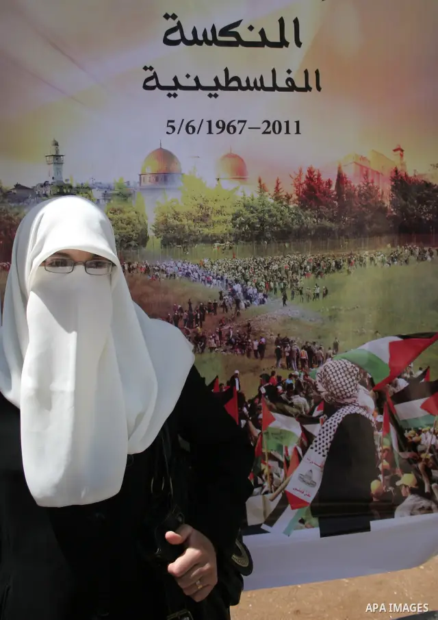 Palestinian Hamas supporters organize a photo gallery for practices of Israeli occupation soldiers and the 44th anniversary of 'Naksa,' Arabic for setback, during a protest in the West Bank city of Hebron on June 05, 201...