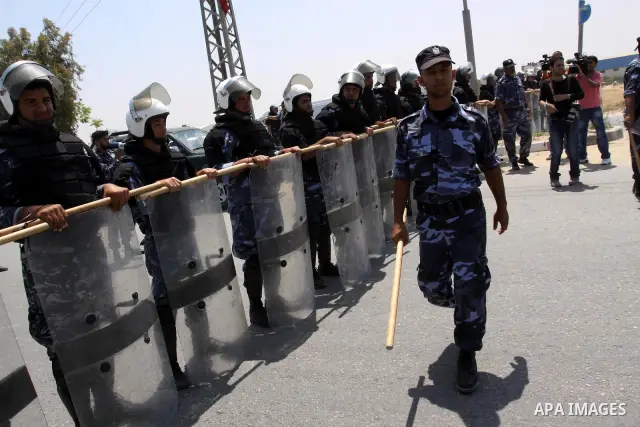 Palestinian Members of Hamas' security forces holds back protesters from reaching Erez border crossing in the northern Gaza Strip, on June 5, 2011, this protest to mark the 44th anniversary of 'Naksa,' Arabic for setback...