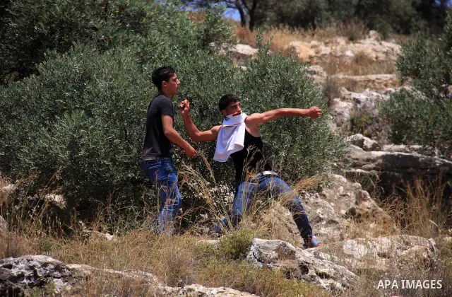 Palestinian protestors clash with Israeli forces following a demonstration against Israeli settlements in the West Bank village of Dair al-Hatab, east of Nablus, on June 5, 2011 as Israeli security forces go on high aler...