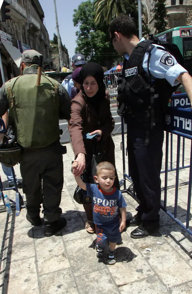 Israeli soldiers stand gurd as Palestinians take part in a protest at Damascus Gate, the main entrance to the old city of Jerusalem, on June 5, 2011 as Israeli security forces go on high alert while Palestinian activists...