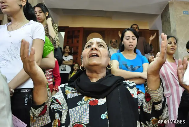 Egyptian Coptic Christians attend Sunday mass at the Virgin Mary church in the Imbaba district of the Egyptian capital of Cairo on June 5, 2011 following the church's restoration after it was burnt during clashes between...