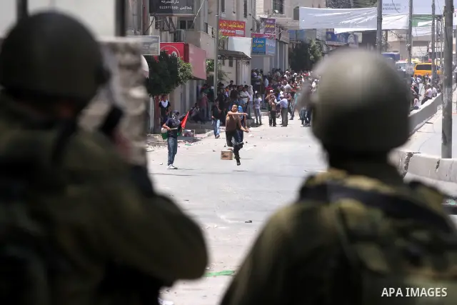 Palestinian demonstrators hurl stones at Israeli soldiers during clashes with Israeli troops at the Qalandia checkpoint, on June 5, 2011 between Jerusalem and the West Bank city of Ramallah. The clashes come on the 44th...