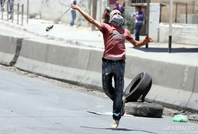 Palestinian demonstrators hurl stones at Israeli soldiers during clashes with Israeli troops at the Qalandia checkpoint, on June 5, 2011 between Jerusalem and the West Bank city of Ramallah. The clashes come on the 44th...