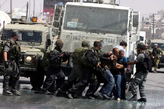 Palestinian demonstrators scuffle with Israeli soldiers during a protest marking the 44th anniversary of the Six Days War on June 5, 2011 at the Israeli-controlled Qalandia checkpoint between Jerusalem and the West bank...