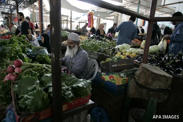 A Palestinian man during showing fresh vegetables at a market in Rafah refugee camp in the southern Gaza Strip on June 6, 2011. Photo by Abed Rahim Khatib