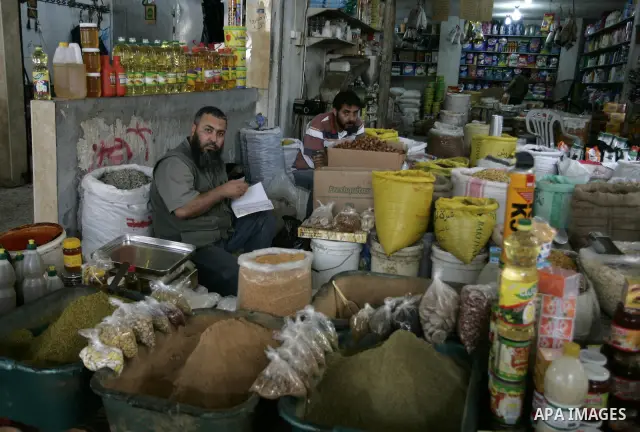A Palestinian man displays Food ration in the market of Rafah refugee camp in the southern Gaza Strip on June 6, 2011. Photo by Abed Rahim Khatib