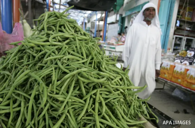 A Palestinian man displays beans in the market of Rafah refugee camp in the southern Gaza Strip on June 6, 2011. Photo by Abed Rahim Khatib