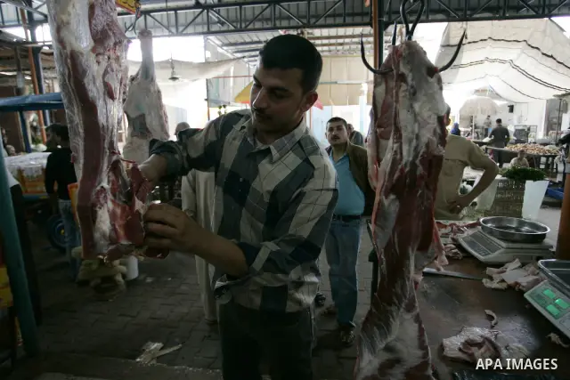 A Palestinian man sells beef in the market in Rafah refugee camp, southern Gaza Strip on June 7, 2011. Photo by Abed Rahim Khatib