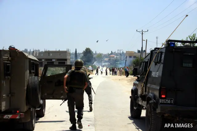 Israeli soldiers fire tear gas canisters during clashes following a protest against Israel's separation barrier in the village Nazlet Issa north Tulkarm in the West Bank on June 7, 2011. Photo by Wagdi Eshtayah