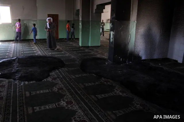 A Palestinian man inspects a partially burn mosque in the West Bank of al-Mughayyir village, some 20 kilometres (12 miles) northeast of Ramallah City on June 7, 2011. Palestinian security sources said Jewish settlers are...