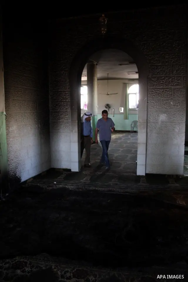 A Palestinian man inspects a partially burn mosque in the West Bank of al-Mughayyir village, some 20 kilometres (12 miles) northeast of Ramallah City on June 7, 2011. Palestinian security sources said Jewish settlers are...