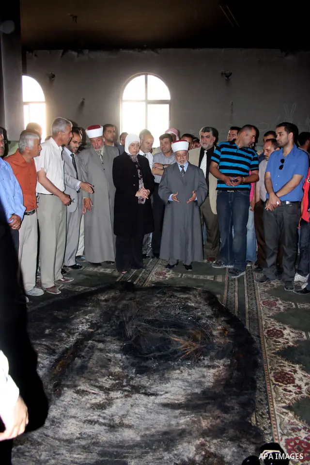A Palestinian man inspects a partially burn mosque in the West Bank of al-Mughayyir village, some 20 kilometres (12 miles) northeast of Ramallah City on June 7, 2011. Palestinian security sources said Jewish settlers are...
