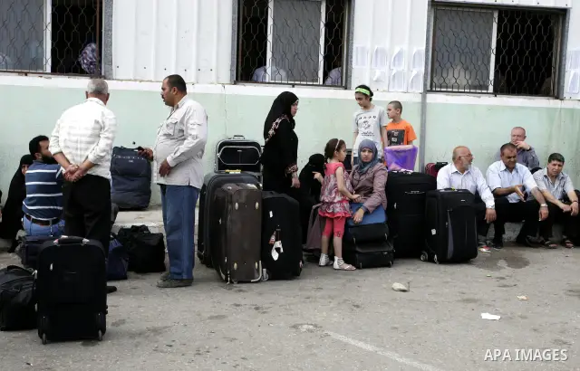Palestinians wait to cross into Egypt through the Rafah border crossing in the southern Gaza Strip on June 8, 2011 after it was reopened, ending a four-day closure amid disagreements between Egyptian and Hamas officials....