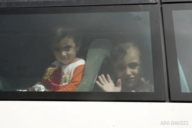 Palestinian girls sit in the bus waiting to cross into Egypt through the Rafah border crossing in the southern Gaza Strip on June 8, 2011 after it was reopened, ending a four-day closure amid disagreements between Egypti...