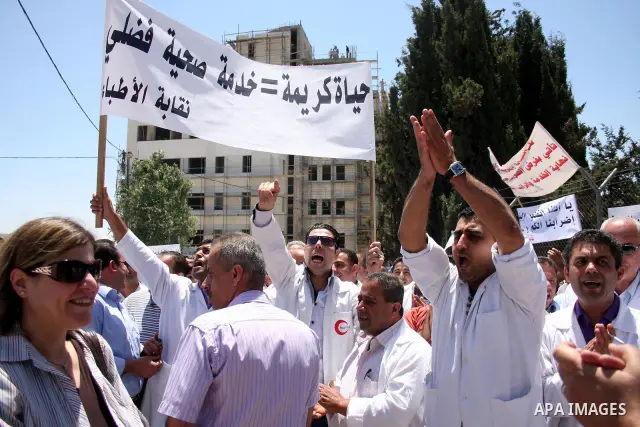 Palestinian doctors protest in front of the Prime Minister Salam Fayyad office in the West Bank city of Ramallah, Wednesday on June 8, 2011 as the Palestinian High Court decided to stop the strike. Photo by Issam Rimawi
