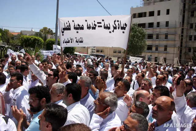 Palestinian doctors protest in front of the Prime Minister Salam Fayyad office in the West Bank city of Ramallah, Wednesday on June 8, 2011 as the Palestinian High Court decided to stop the strike. Photo by Issam Rimawi