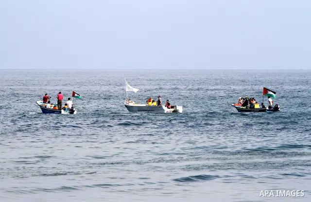 Foreign activists ride their Oliva boat to monitor the violations of the Israeli forces against the Palestinian fishermen in the Mediterranean Sea off the coast of Gaza City on June 8,2011.. Photo by Mohammed Asad