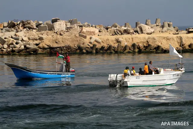 Foreign activists ride their Oliva boat to monitor the violations of the Israeli forces against the Palestinian fishermen in the Mediterranean Sea off the coast of Gaza City on June 8,2011.. Photo by Mohammed Asad
