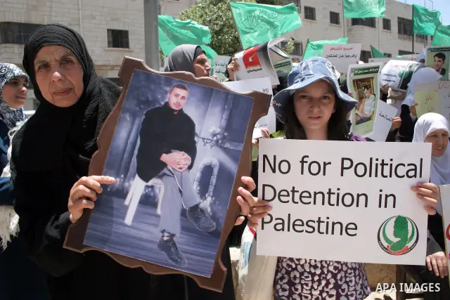 Palestinian Hamas supporters hold up pictures of relatives who were arrested and imprisoned for political reasons by Palestinian Authority security forces, during a protest in the West Bank city of Hebron, on June 09,201...