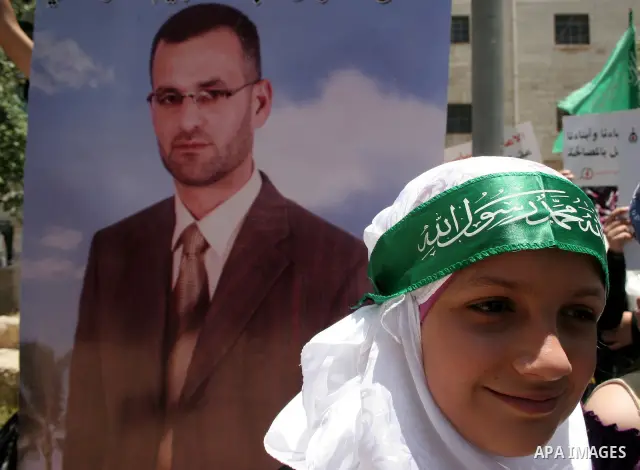 Palestinian Hamas supporters hold up pictures of relatives who were arrested and imprisoned for political reasons by Palestinian Authority security forces, during a protest in the West Bank city of Hebron, on June 09,201...